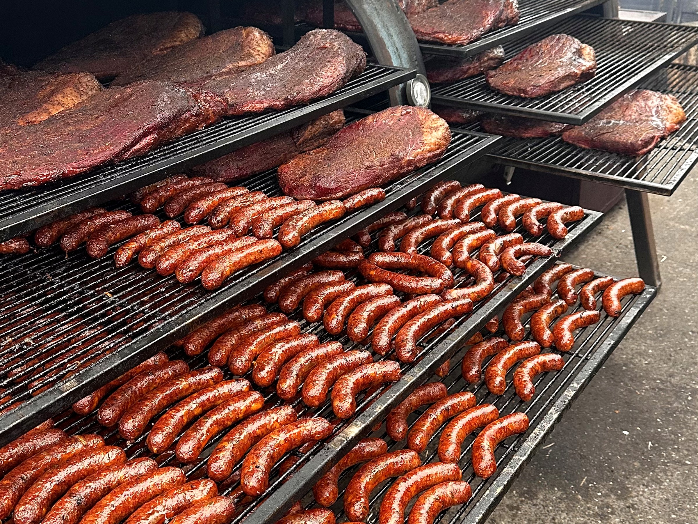 Smoker mit Würsten und Brisket